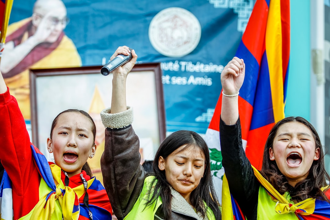 a group of people holding up flags and microphones