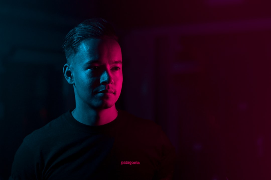 man standing inside room with neon lights