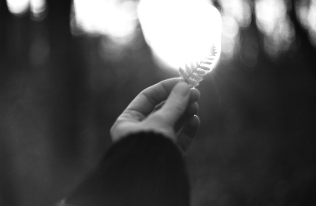 A person holding a toothbrush in their hand
