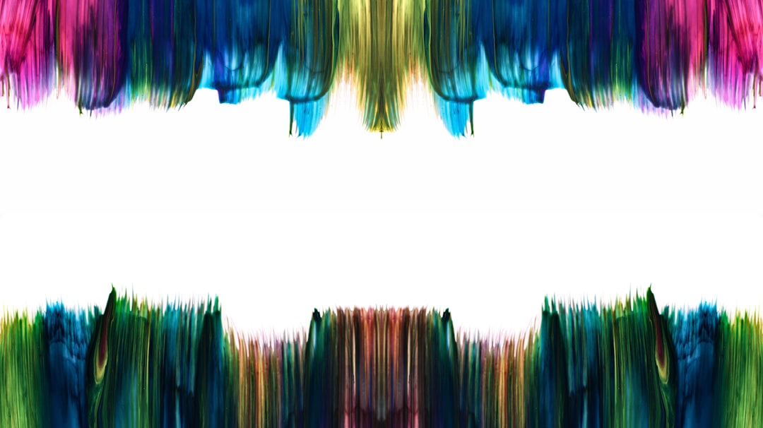 Colorful abstract brush strokes border a white space.
