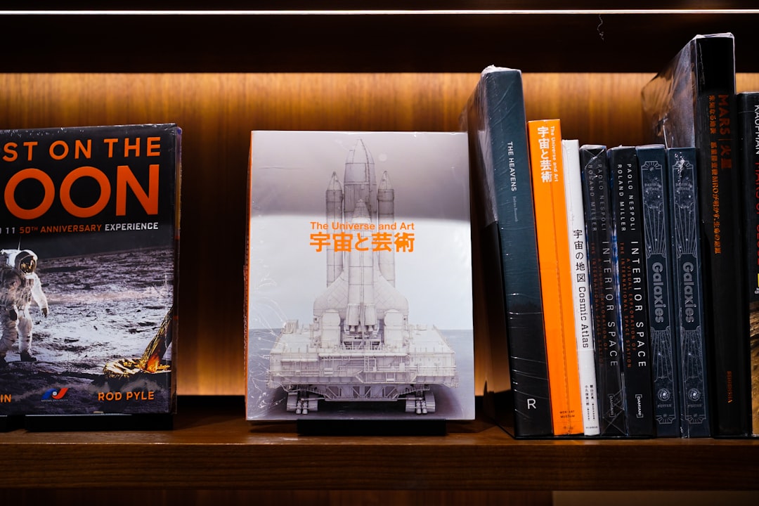 a book shelf filled with books and a space shuttle