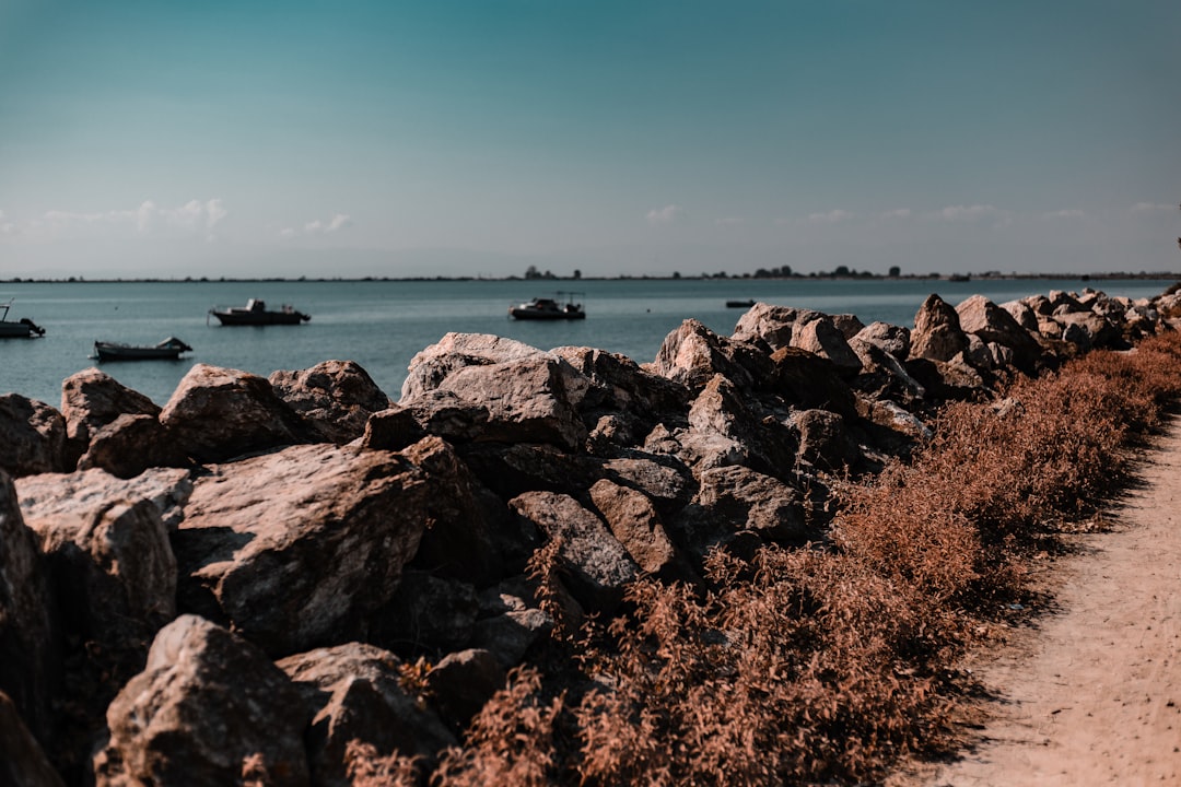 several boats are in the distance on the water