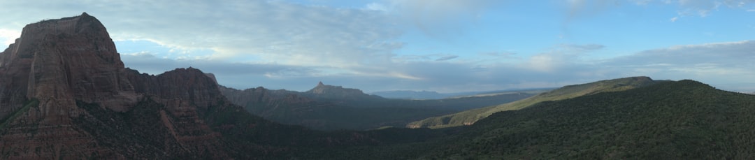a view of a mountain range from the top of a hill